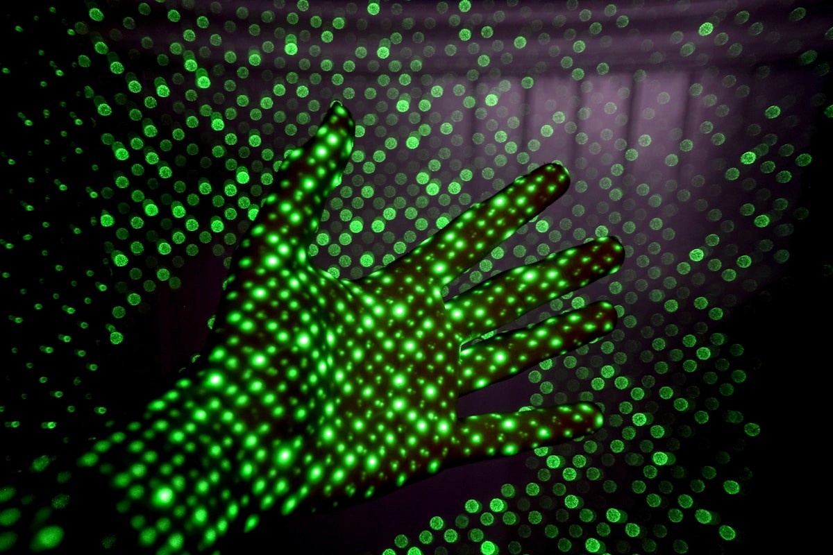 Hand illuminated by green LED light